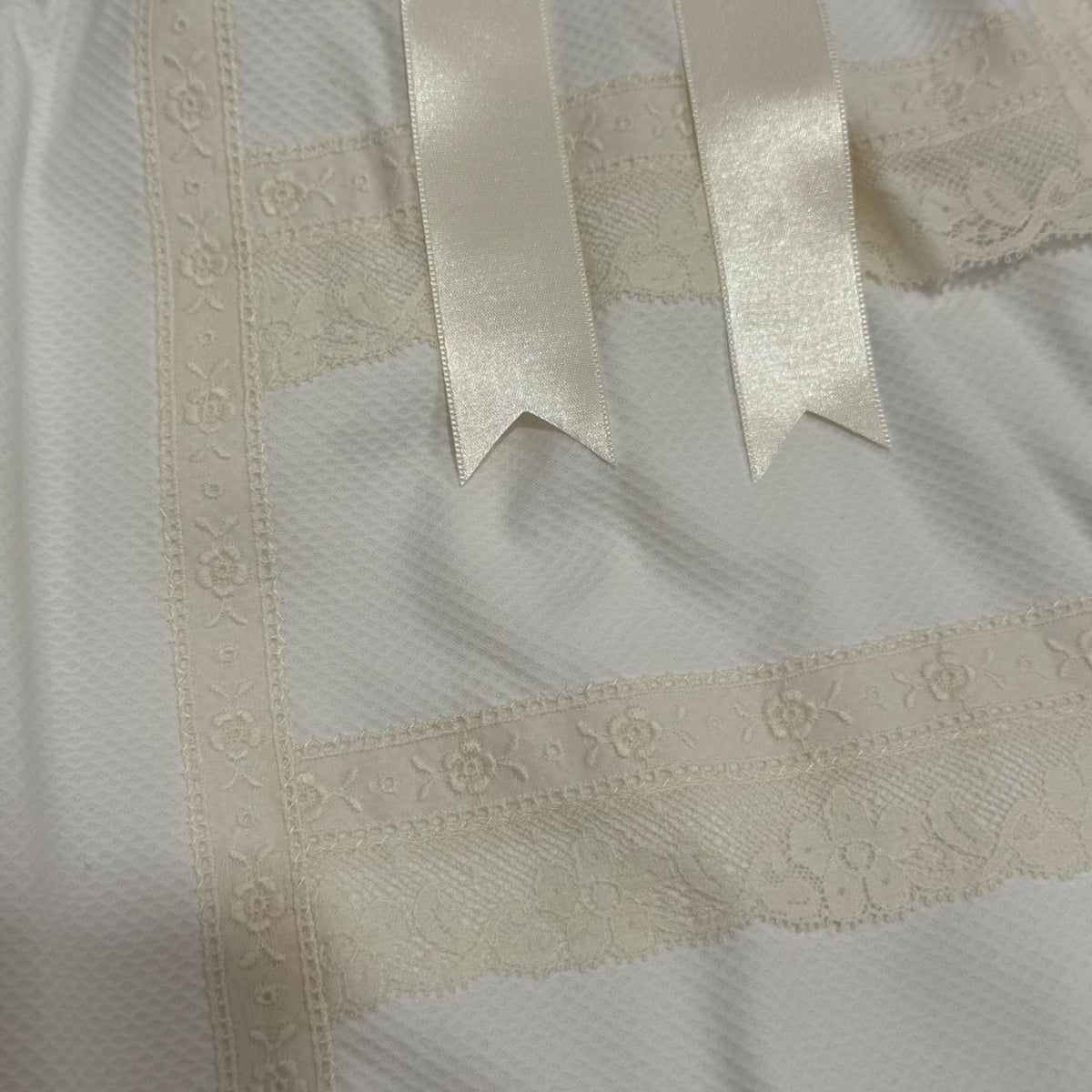Close-up of beige lace and ribbon detailing on Gladys Pique Faldon Skirt