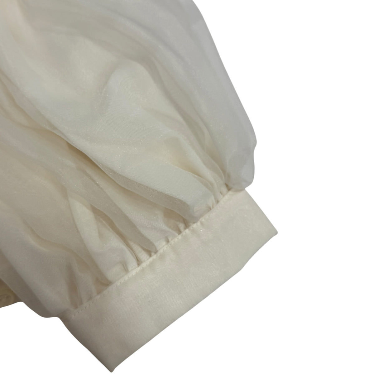 Close-up of puffed sleeve and cuff detailing on Lionel Ivory Romper