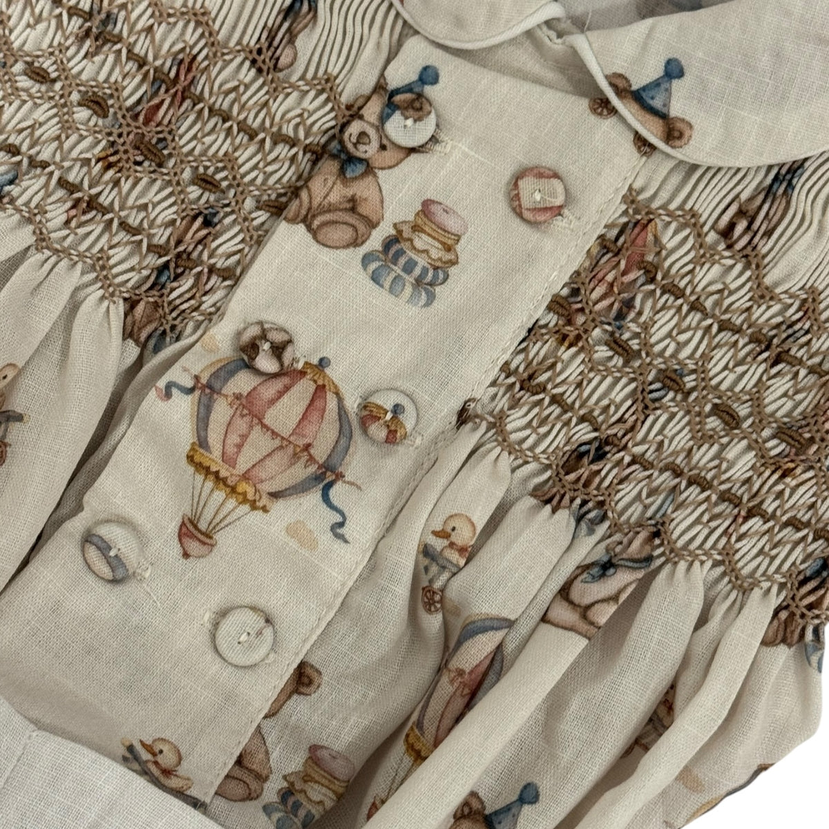 Close-up of birthday bear print and handsmocking on Birthday Bear Boy Set