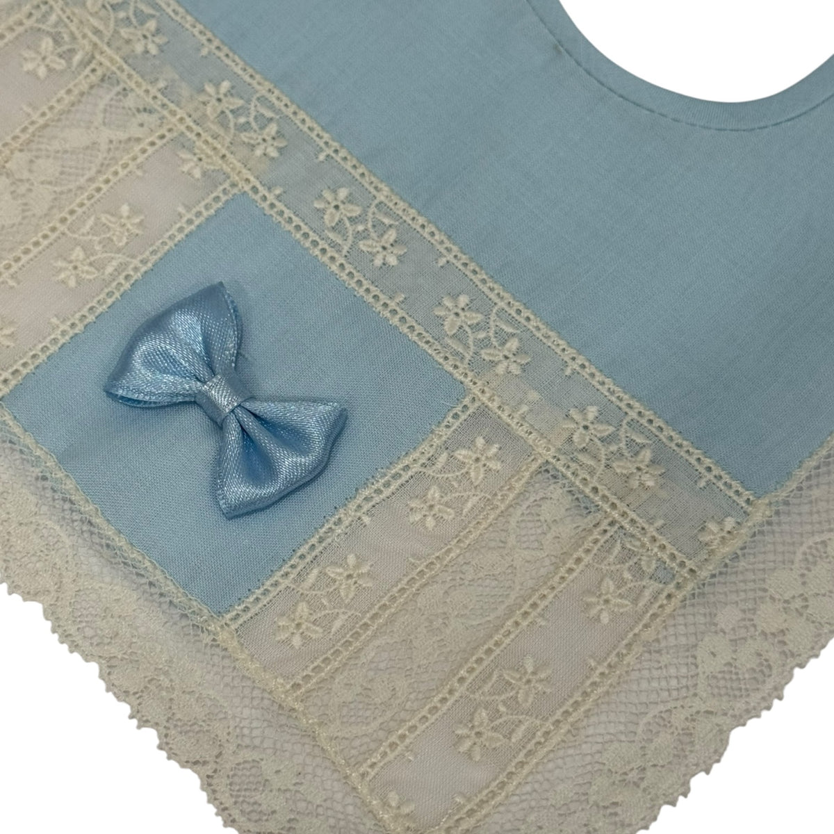 Close-up of ivory lace and blue bow detailing on Marilyn Light Blue Bib
