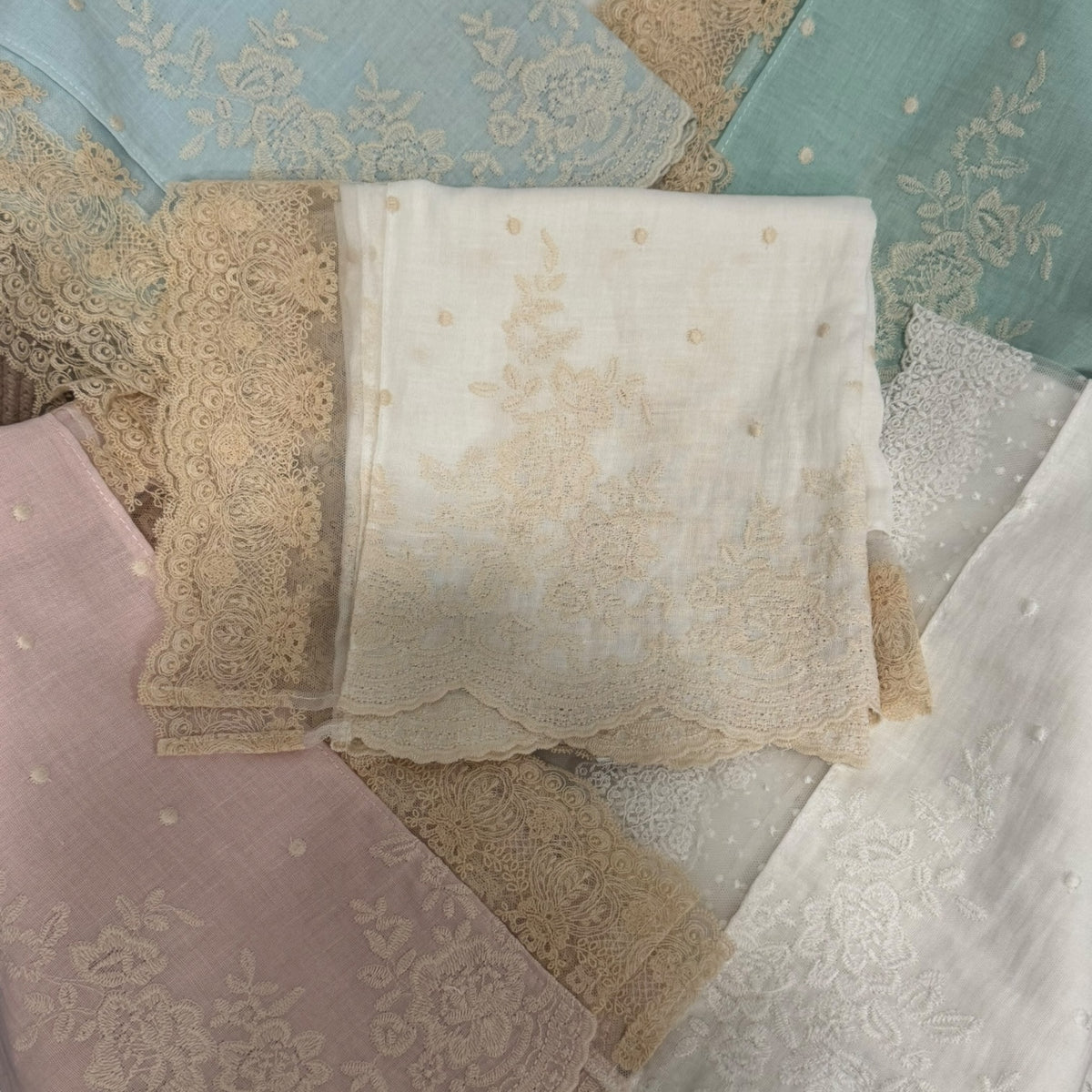 Close-up of light blue linen and ivory lace detailing on Dominique Blanket