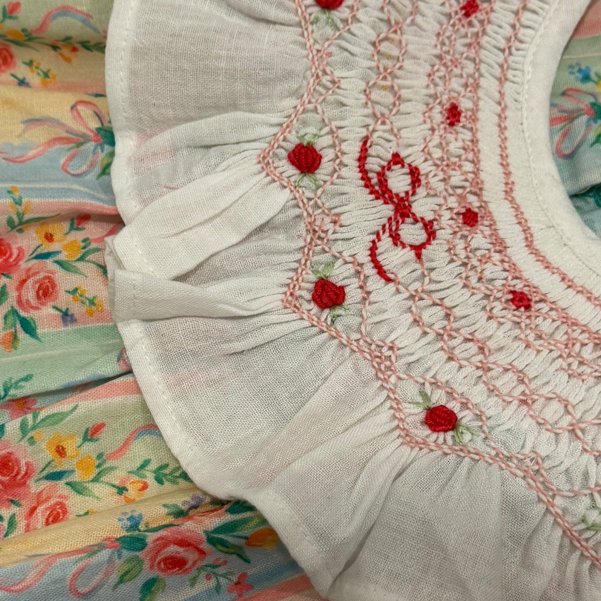 Close-up of handsmocking and embroidered detailing on Eloisa Bow Handsmocked Dress