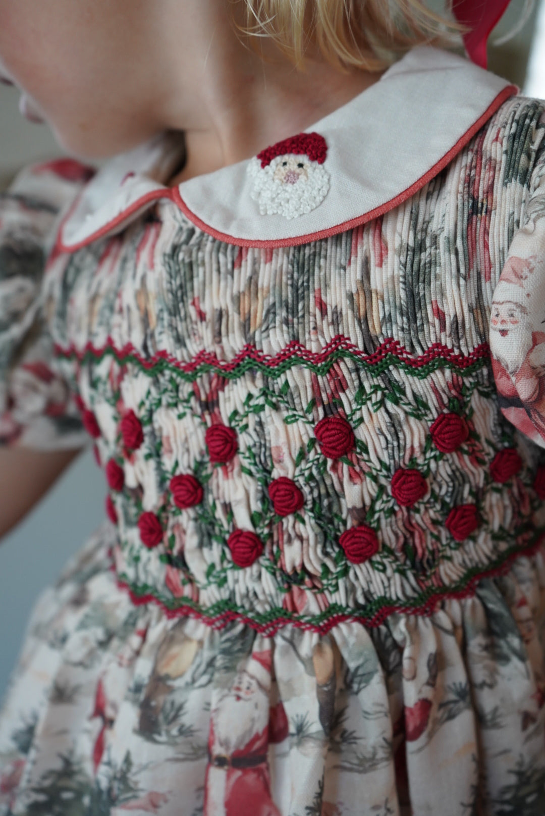 Close-up of red and green handsmocking on The Santa Claus Christmas outfit