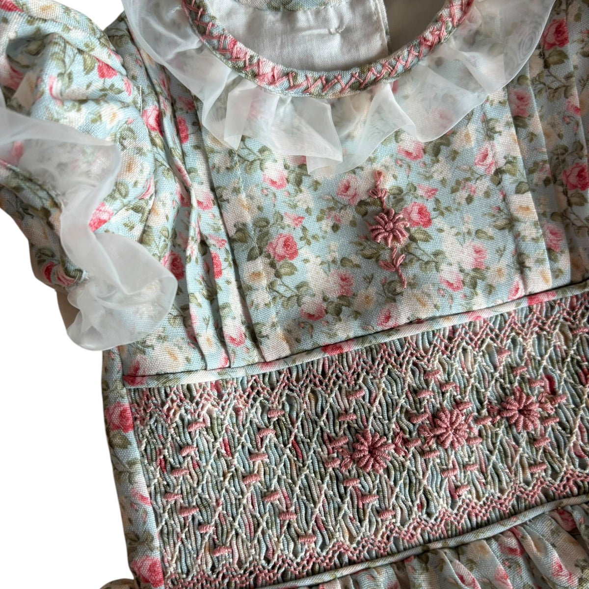 Close-up of floral print and handsmocked bodice on Nancy Vintage Roses Dress