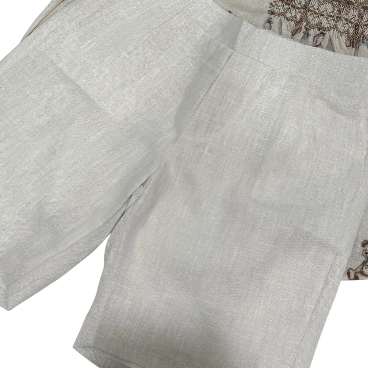 Close-up of coordinating ivory shorts from Birthday Bear Handsmocked Boy Set