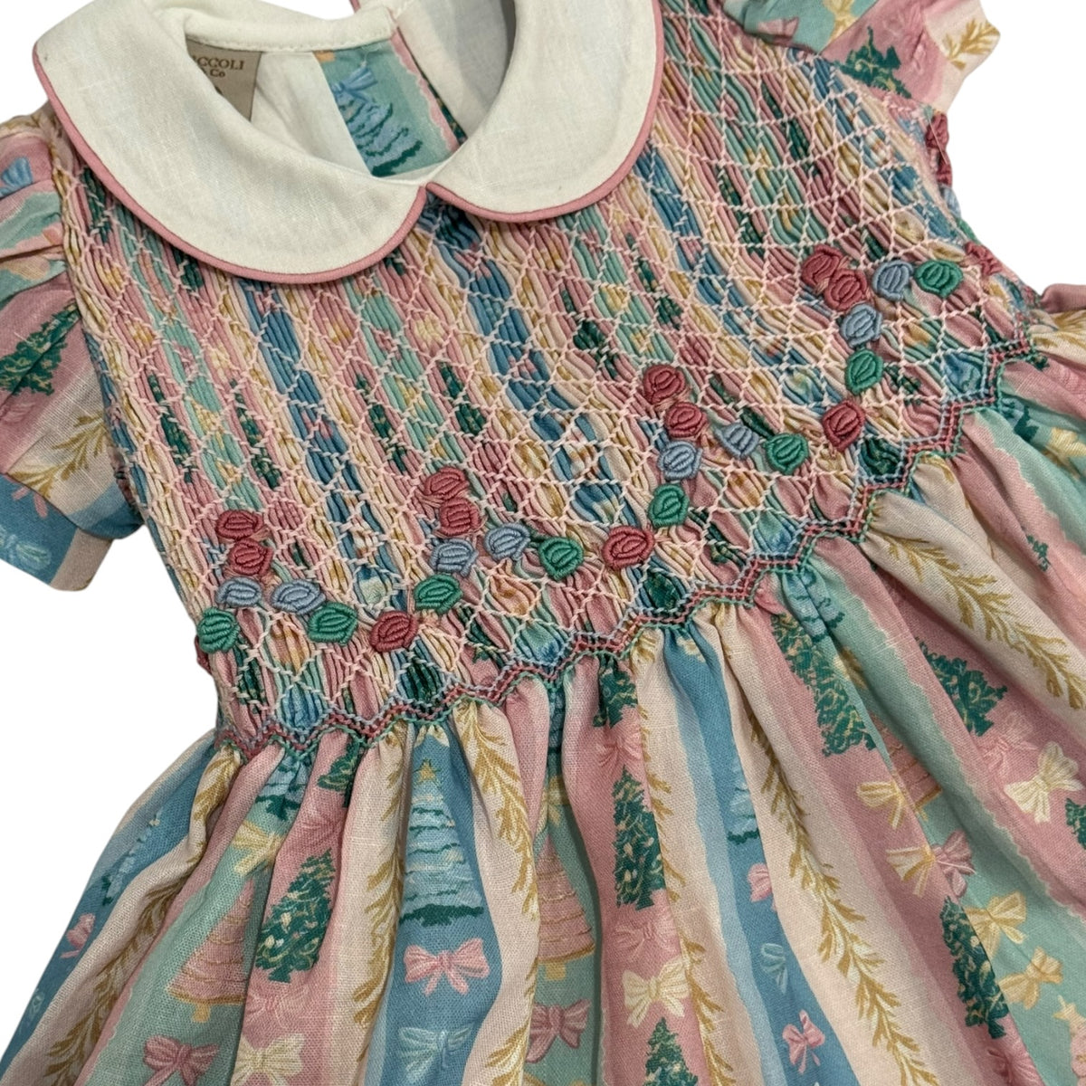 Close-up of ivory collar, pastel tree print and colorful handsmocking on Christmas Tree Pastels Dress