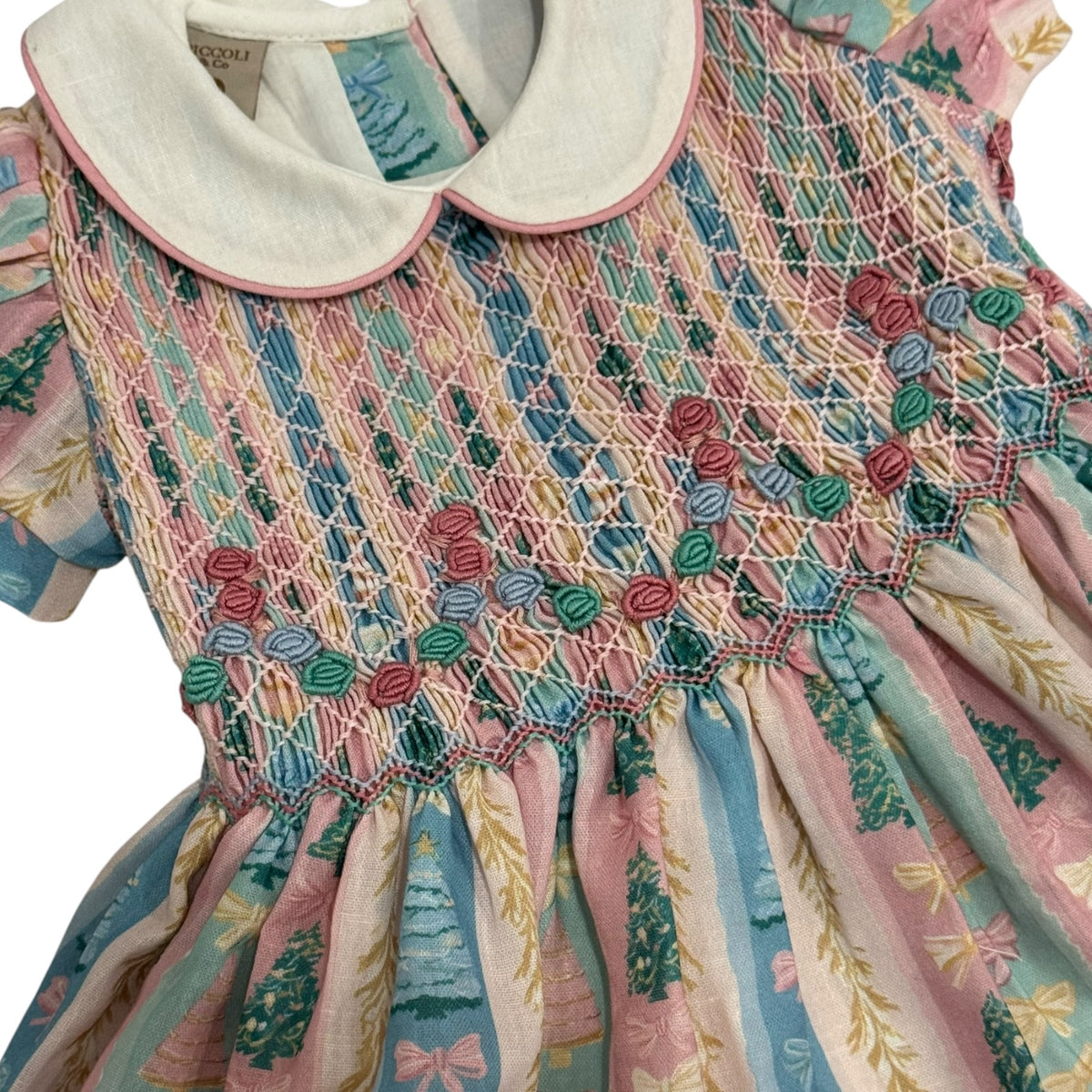 Close-up of rounded ivory collar and intricate handsmocking on Christmas Tree Pastels Dress