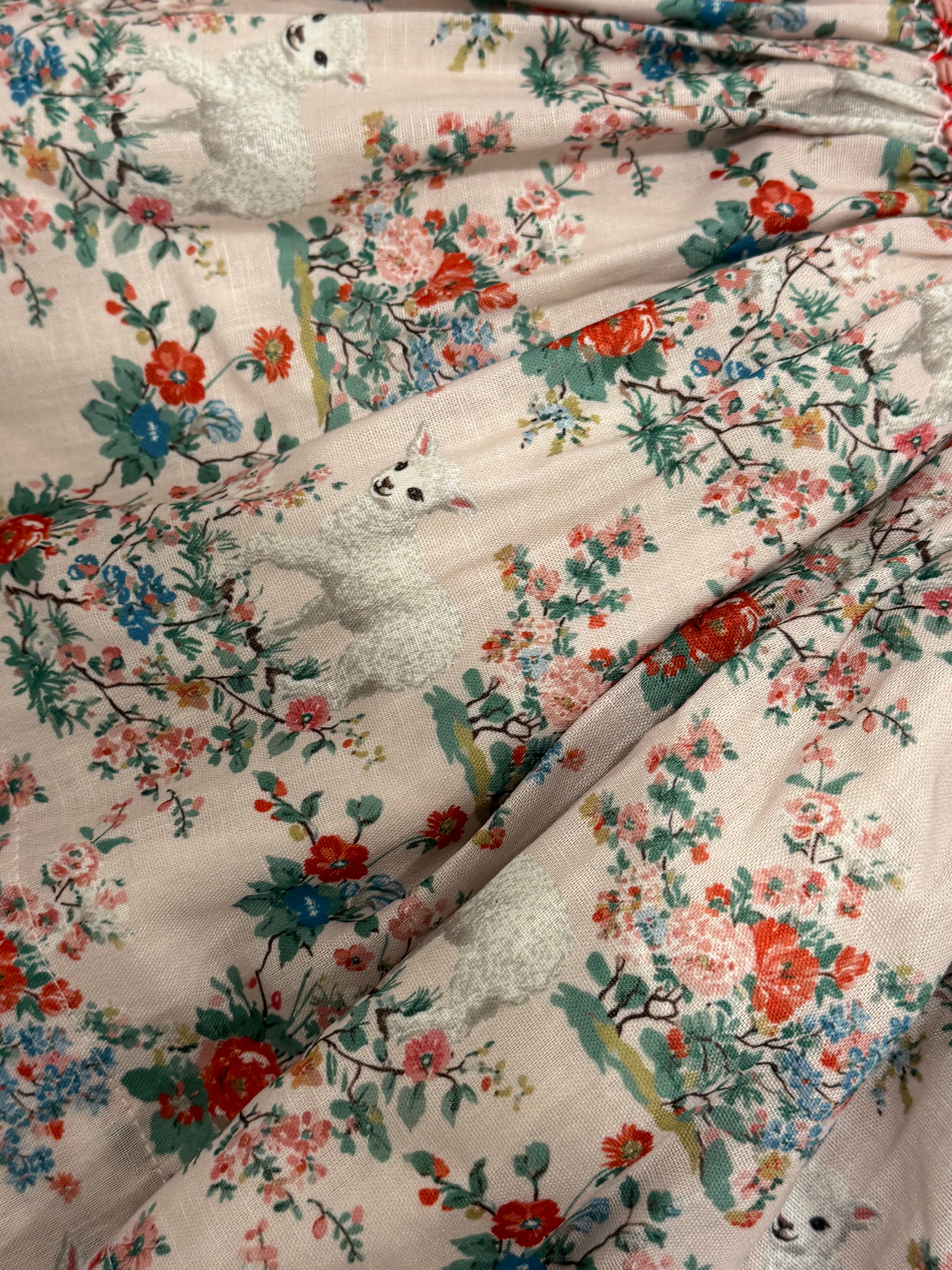 Close-up of lamb and floral print detailing on Lamb Red Floral Dress