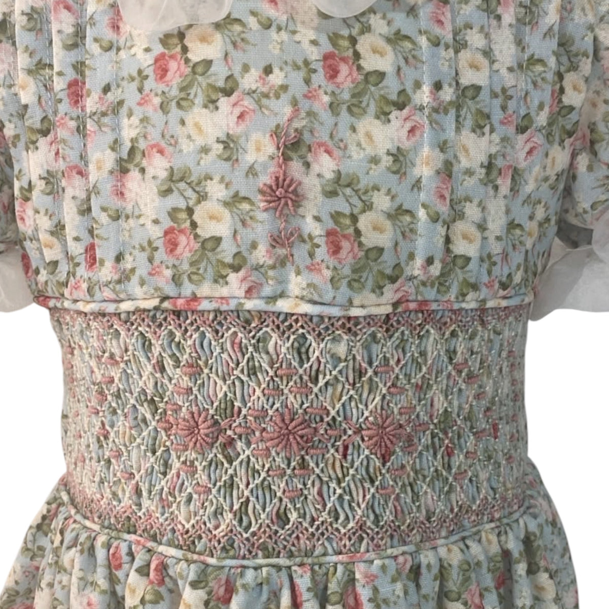 Close-up of intricate handsmocking and vintage rose print on Nancy Handsmocked Dress