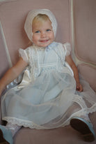 Girl wearing Addison Luxe Light Blue Handsmocked Dress