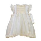 Emma Luxe Ivory Handsmocked Dress with lace detailing and satin bows