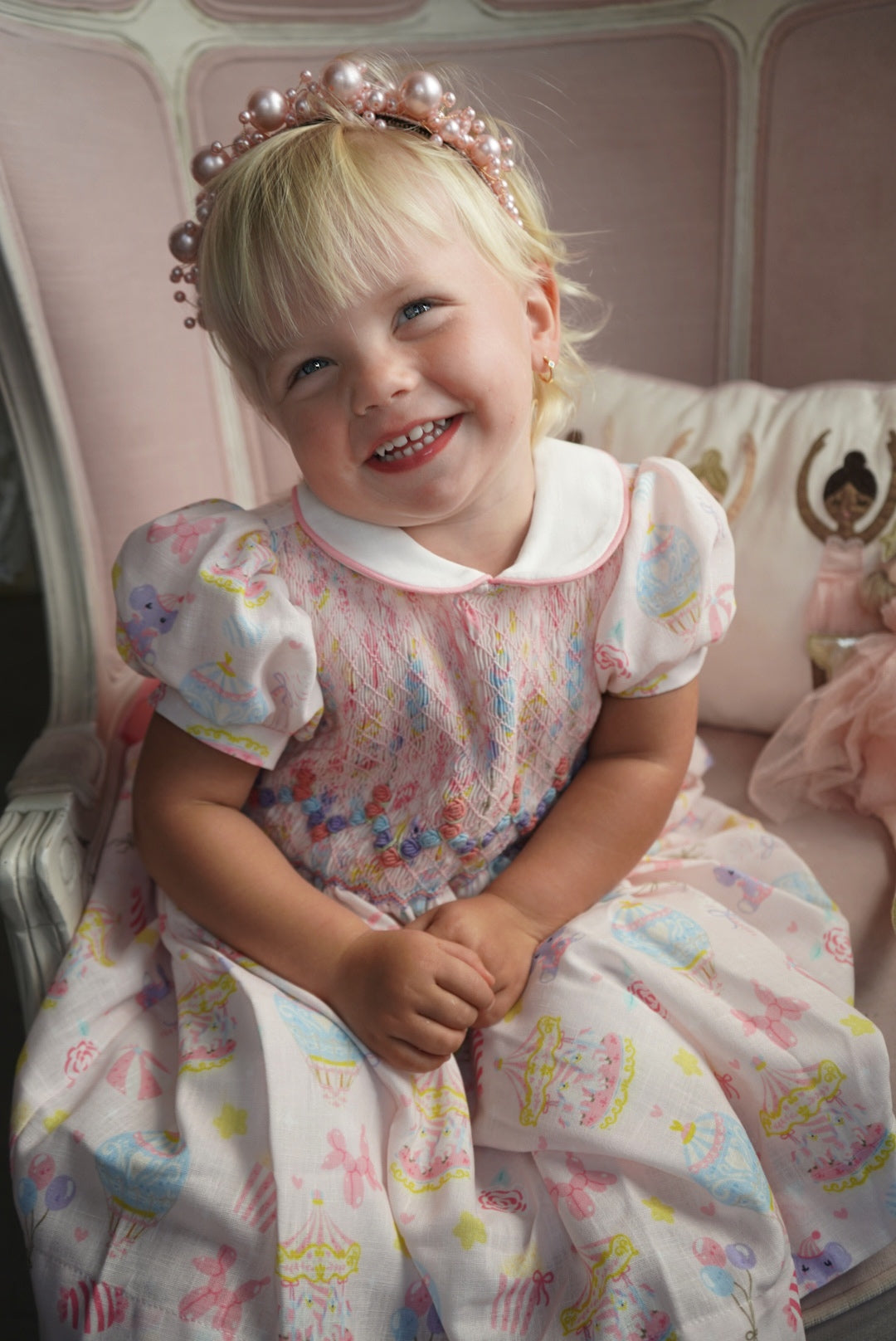 Girl wearing Carnival Carousel Girl Dress with coordinating back bow