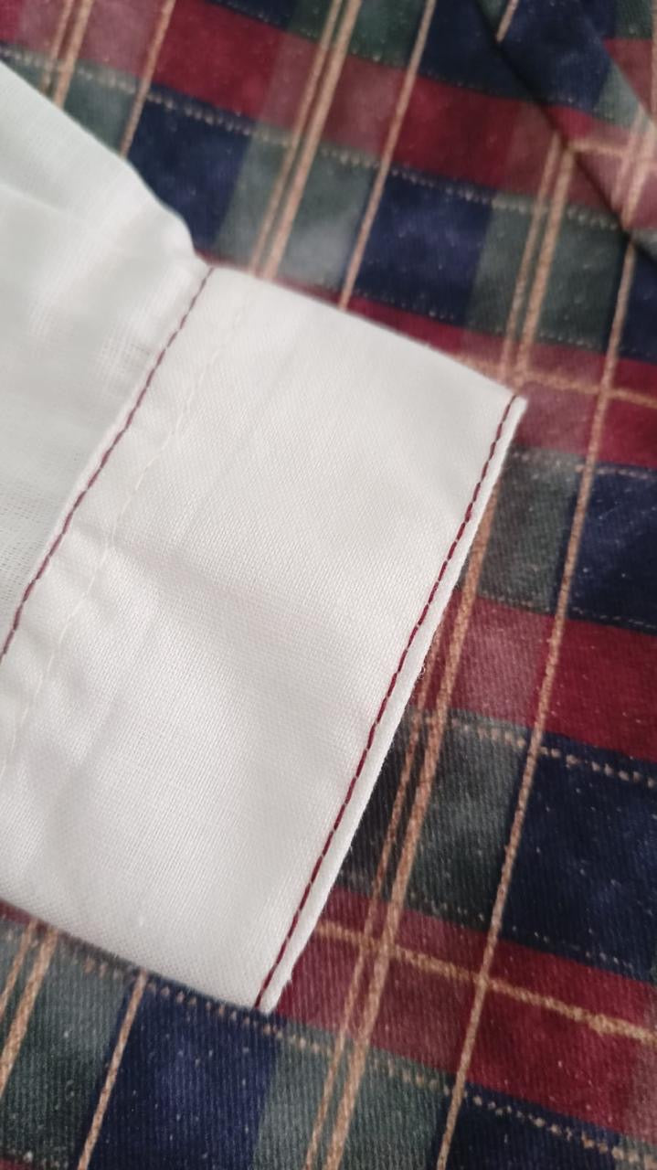 Close-up of red embroidered detailing on Tartan Luxe Boy Christmas shirt
