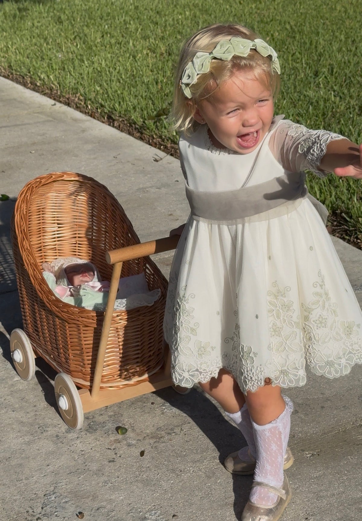 Girl wearing Tessa Velvet Bow Headband in spring moss with three satin and velvet bows