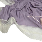 Close-up of ivory lace border and purple knit on Aida Rose Luxe Blanket