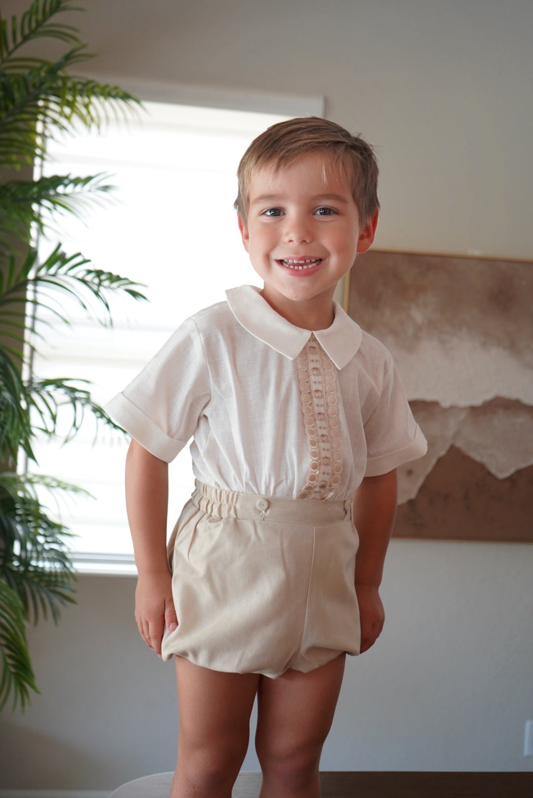 Boy wearing ivory and beige two-piece set with embroidered front detailing