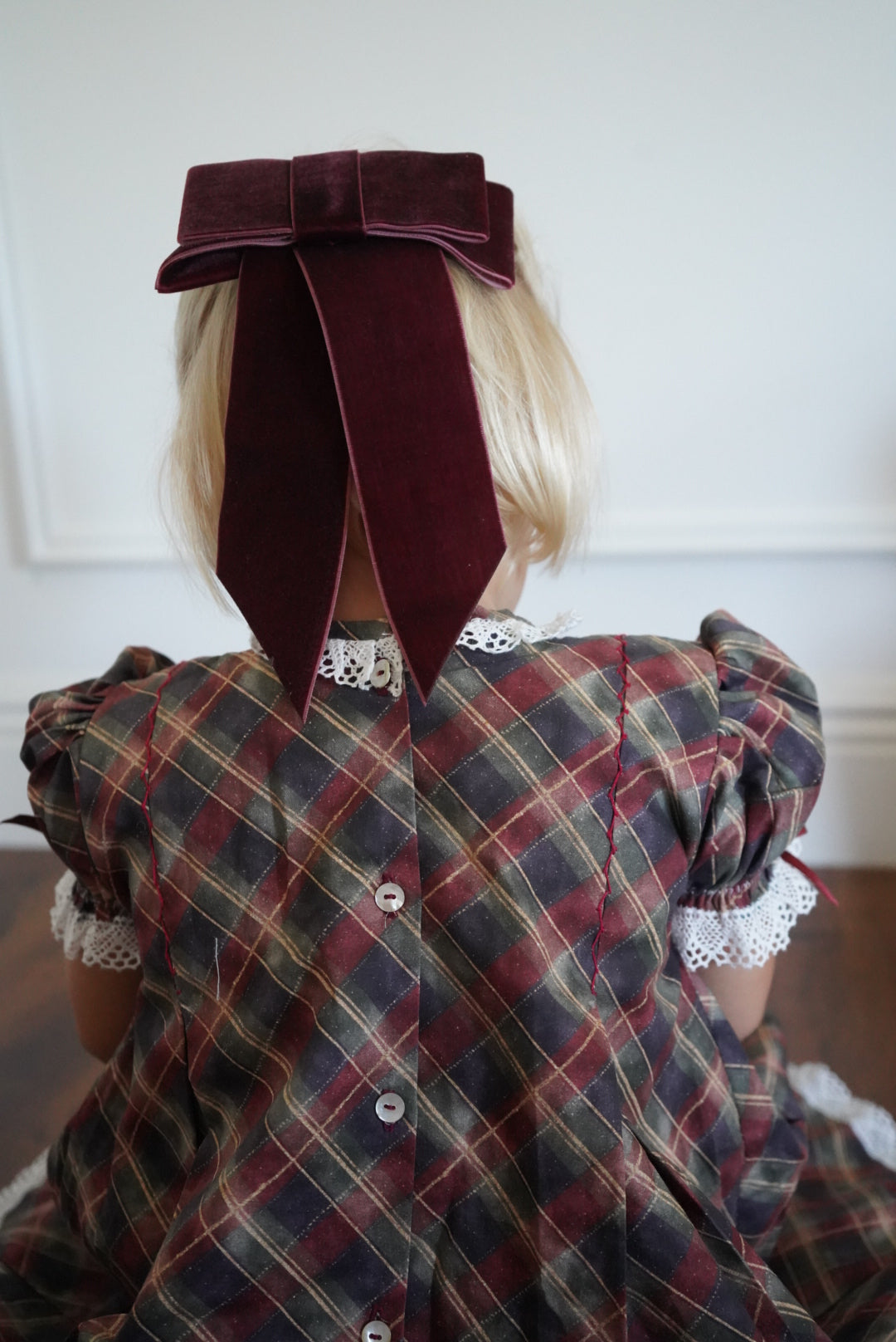 Close-up of back ribbon bow and tartan fabric on Tartan Luxe Handembroidered Dress
