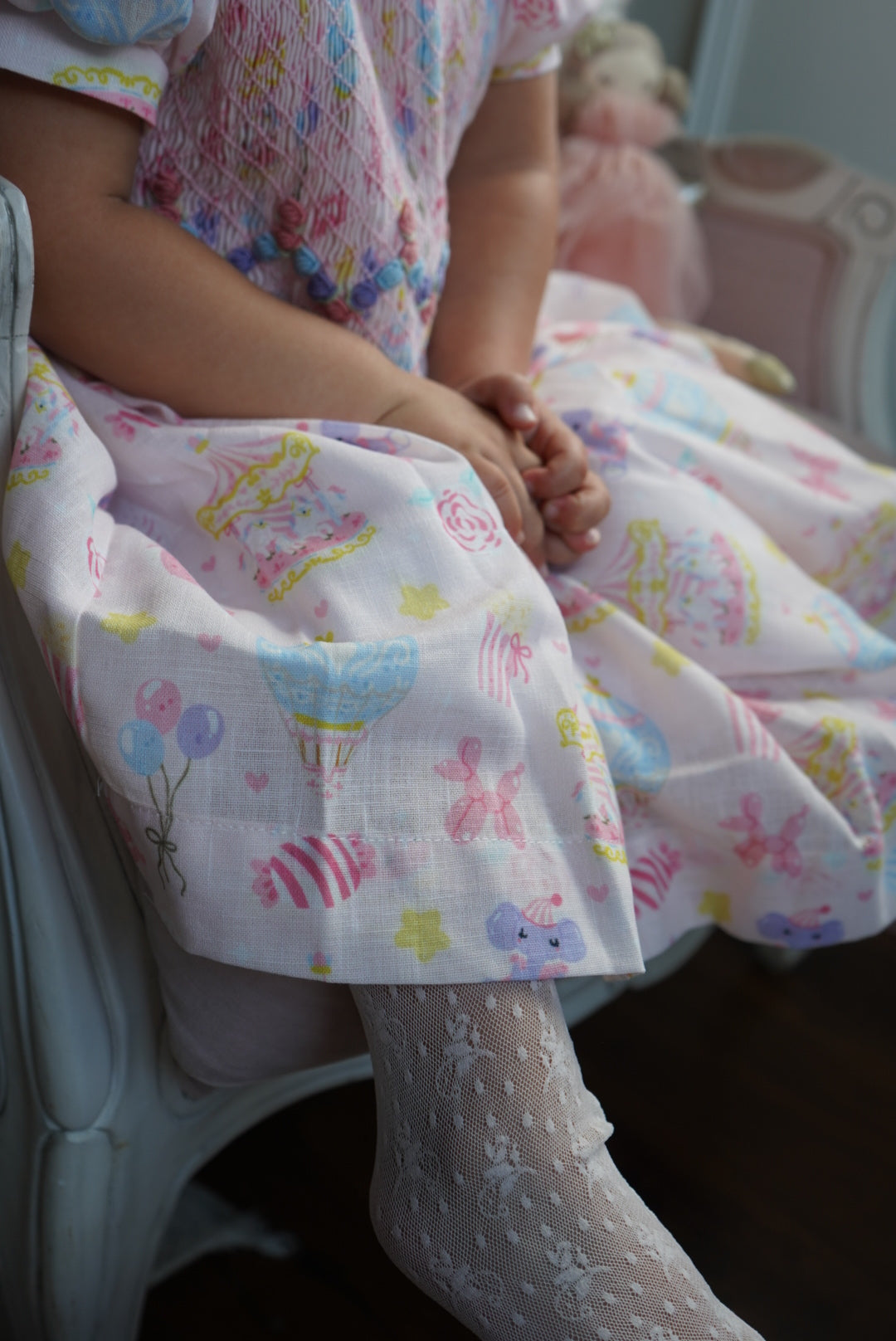 Girl wearing Carnival Carousel Handsmocked Dress indoors
