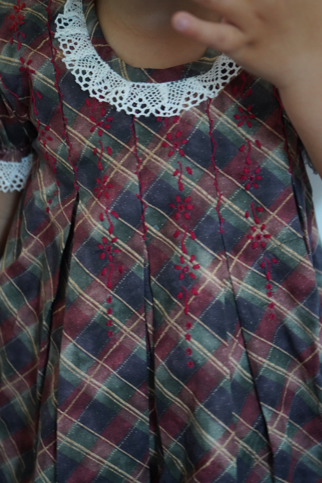 Close-up of tartan fabric and delicate hand embroidery on Tartan Luxe Dress

