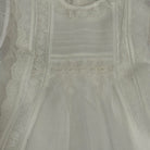 Close-up of tonal ivory detailing on Addison Luxe White Handsmocked Dress