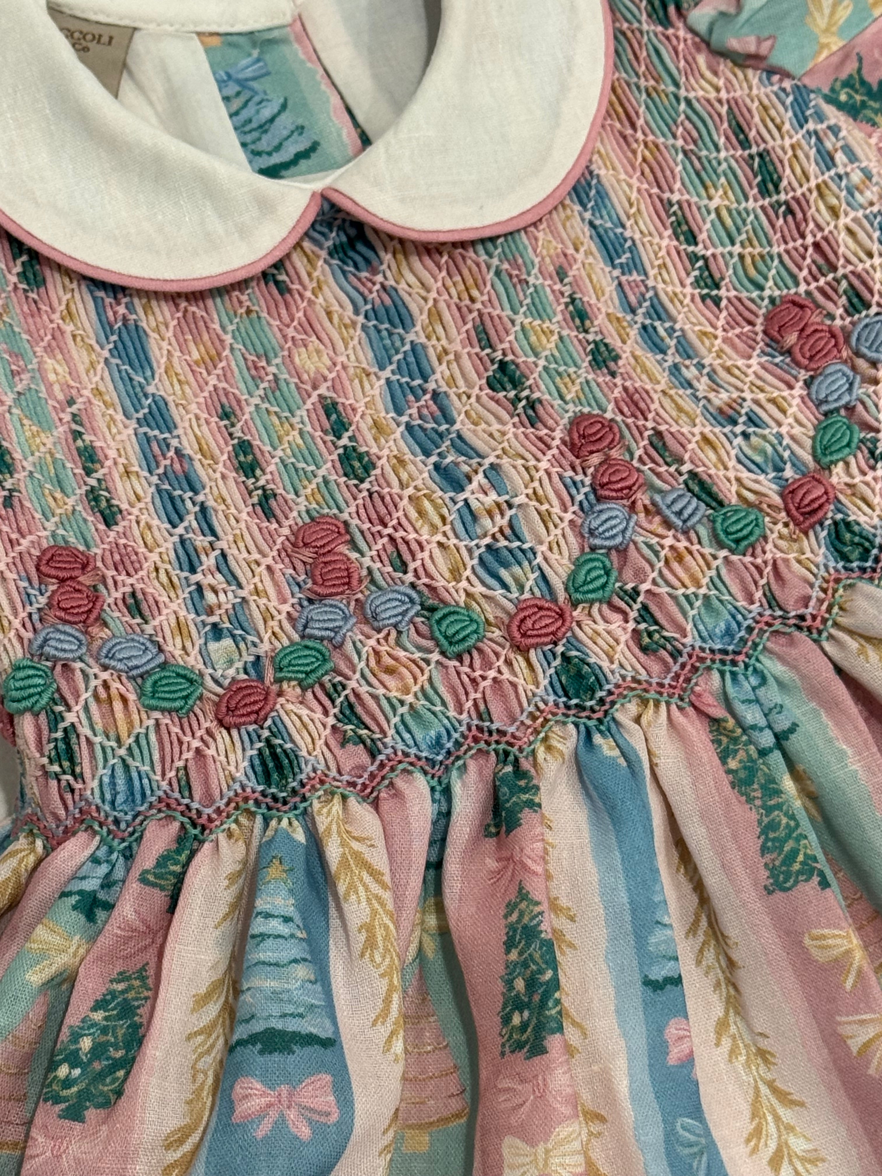 Close-up of ivory collar, pastel tree print and handsmocking on Christmas Tree Pastels Romper