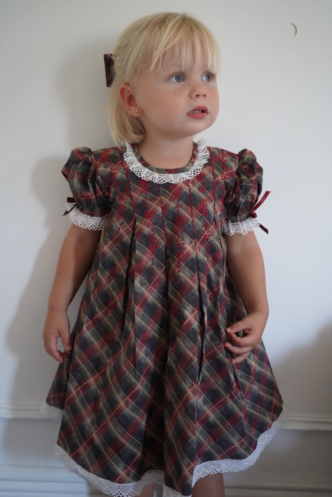 Girl wearing Tartan Luxe Handembroidered Dress indoors
