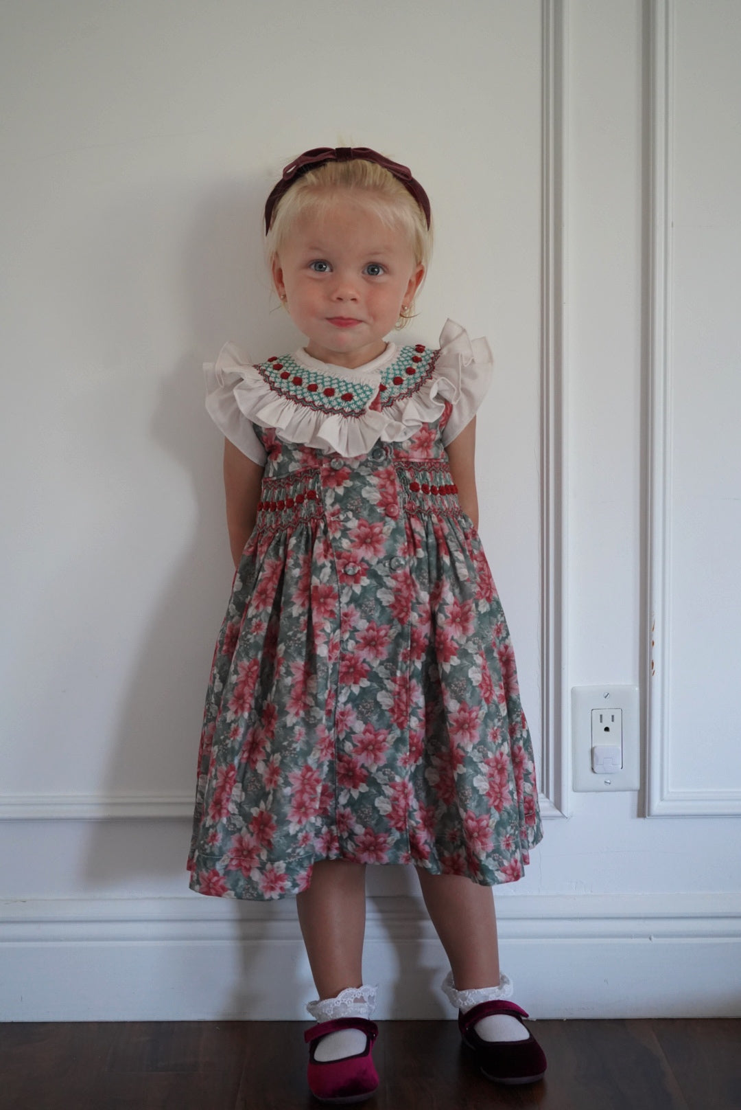 Girl wearing Christmas Florals Handsmocked Dress