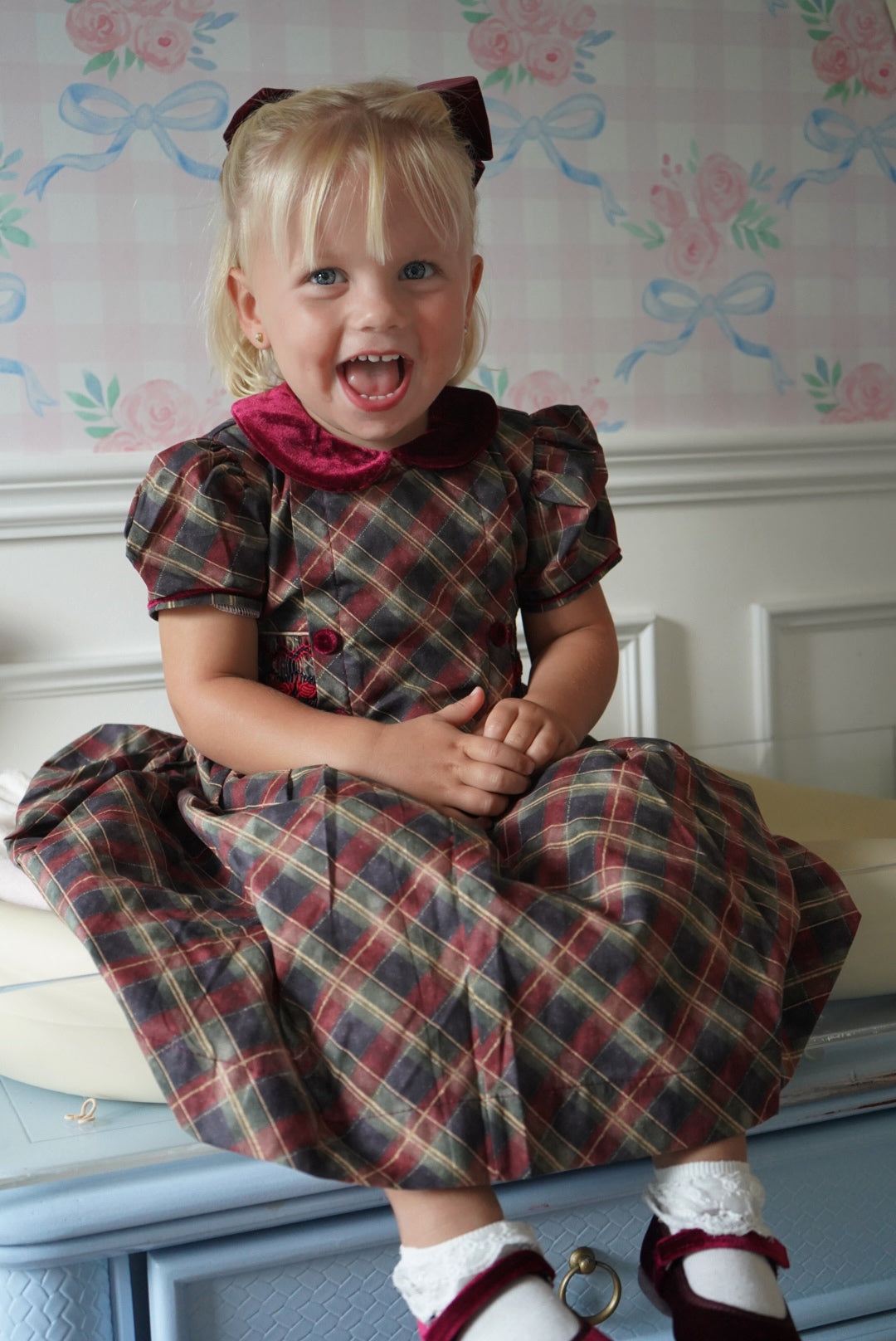 Girl wearing Tartan Luxe Handsmocked Christmas Dress