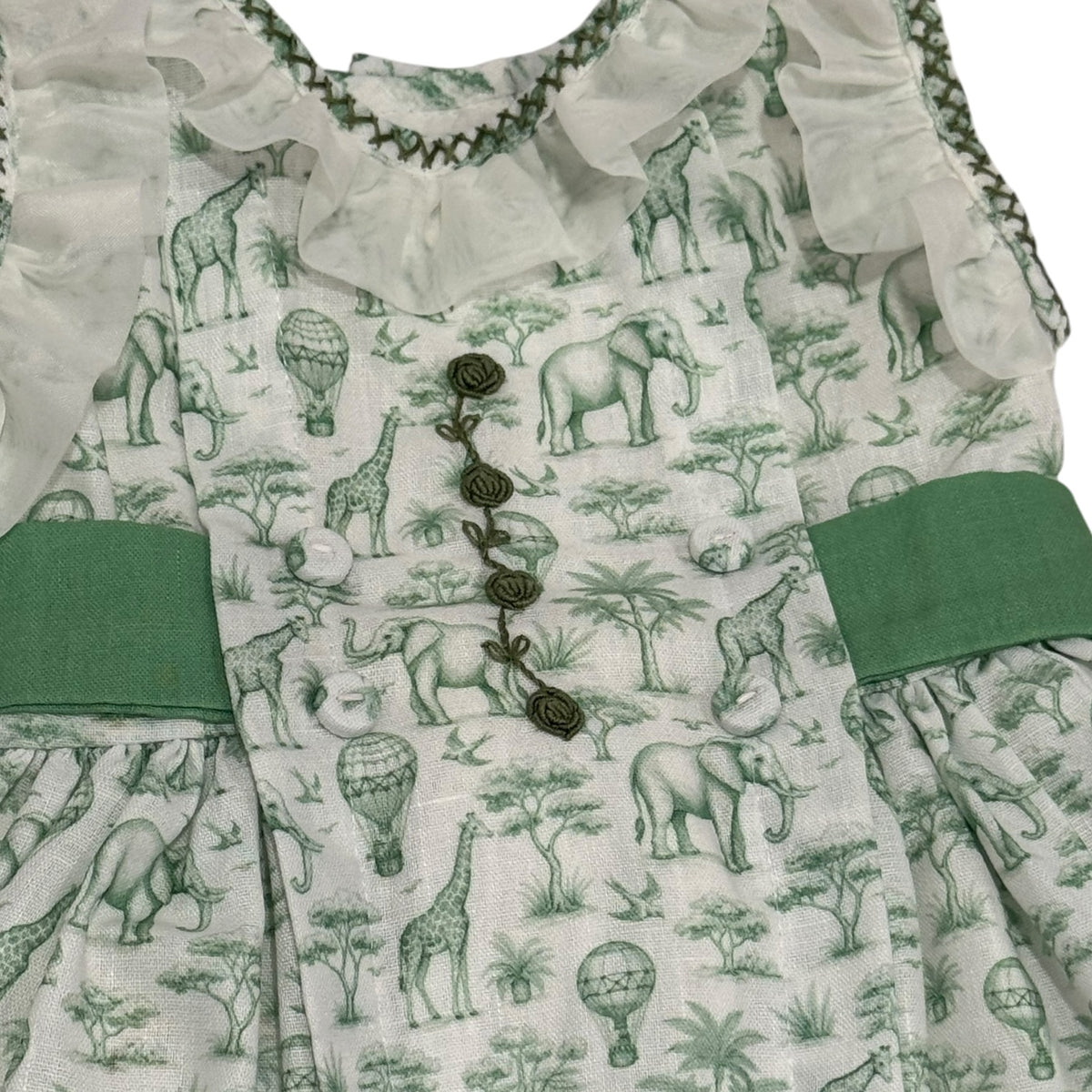 Close-up of hand-embroidered detailing and green waist accents on Safari Green Toile Dress
