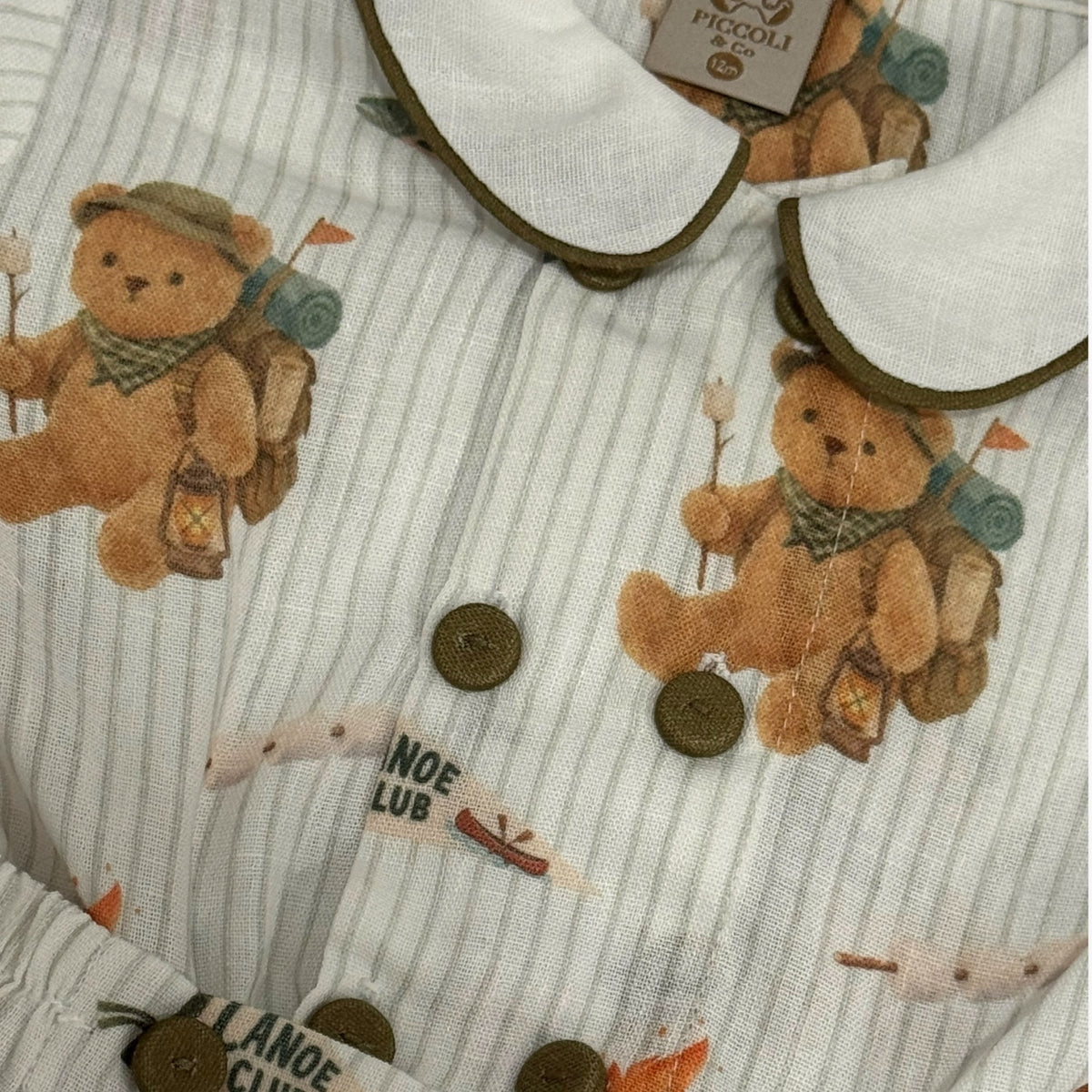 Close-up of rounded collar and green trim on Let's Go Camping Bears Boy Set