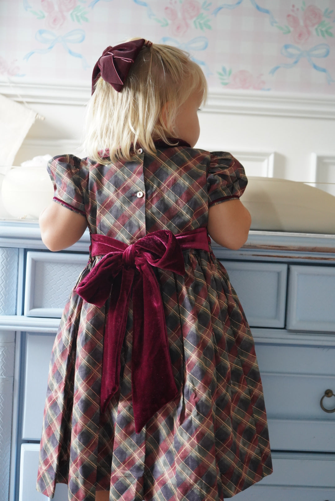 Back view of Tartan Luxe Handsmocked Girl Dress with velvet bow